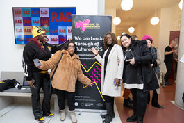 4 women stand next to the We are London Borough of Culture 2025 pull-up banner