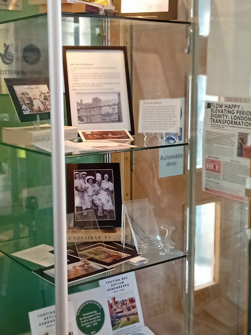 Display of photos relted to Tooting Bec Asylum in glass cabinet