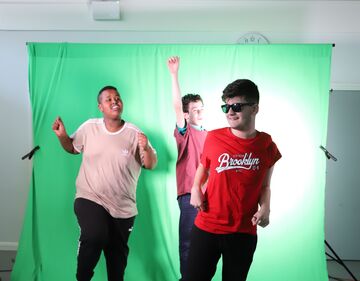 Children jumping in front of green screen