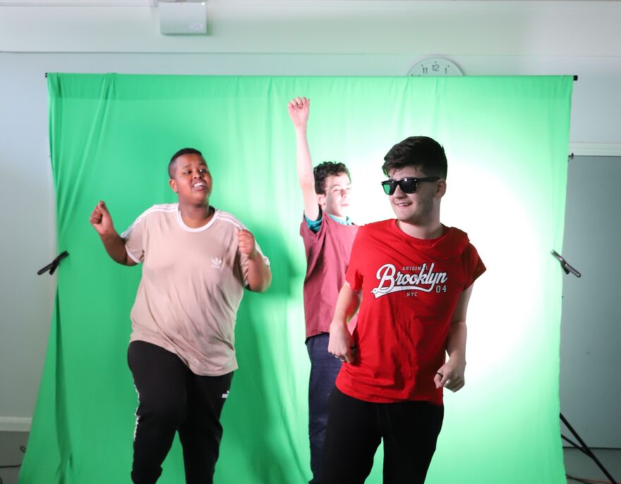 Children jumping in front of green screen