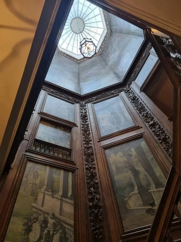 Looking up the middle of a grand spiraling staircase