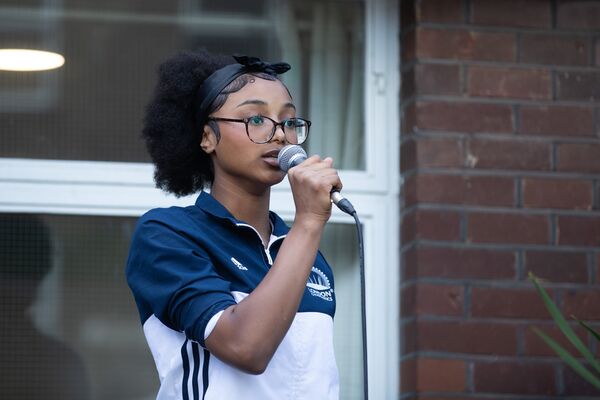 Young person holding microphone up to their face