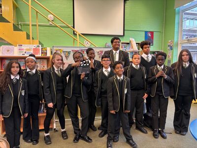 group of students with a clapper board