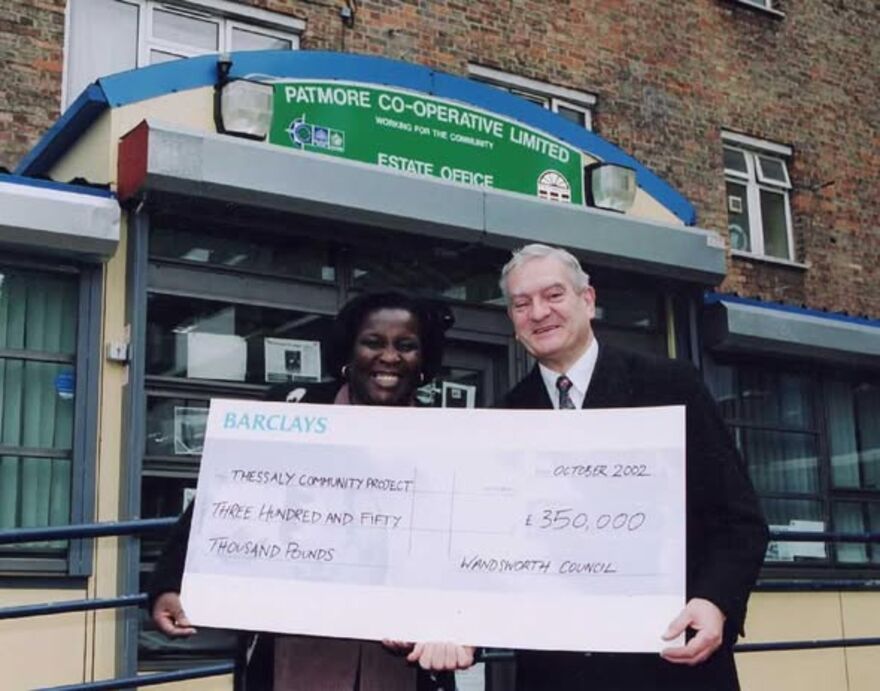 Yvonne Carr and Cllr Maurice Heaster holding oversized cheque and smiling into the camera