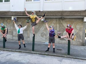 Four costumed dancers in various poses by the Winstanley Estate