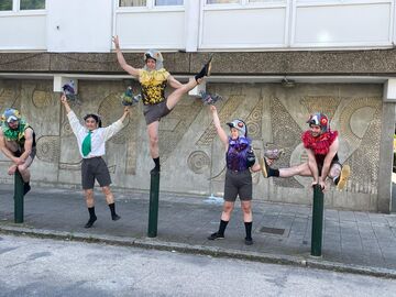 Four costumed dancers in various poses by the Winstanley Estate