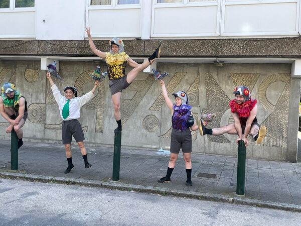 Four costumed dancers in various poses by the Winstanley Estate