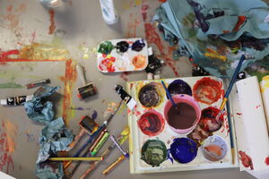 photo of paints and paint brushes on a table