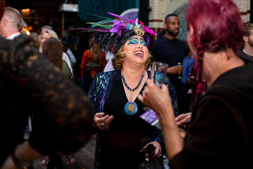 A woman in a feathered headdress laughing