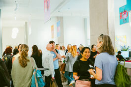 A group of people stand in the foyer of the Royal Academy of Dance chatting