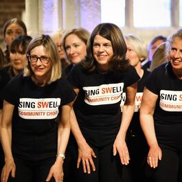 Female singers all in black t-shirts with writing that says Sing Swell Community Choir