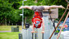 A person does a handstand on two poles, with their legs in a split.