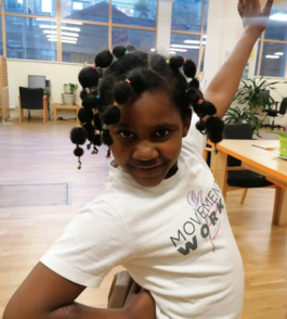 a young black girl strikes a pose wearing a MovementWorks t-shirt