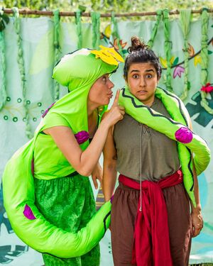 two performers in an outdoor performance of the jungle book