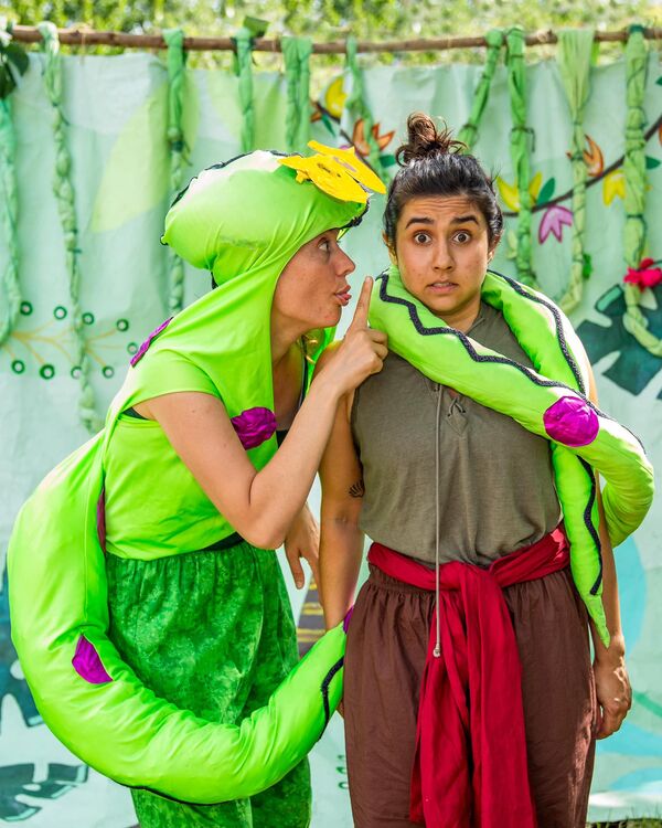 two performers in an outdoor performance of the jungle book