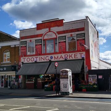 An image of the red front of Tooting Market, as Listed Building