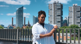 woman stands wirth her elbow on a railing in Battersea