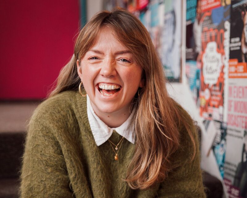 Headshot of Emily Carewe laughing