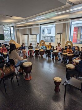 Group of children playing djembe drums