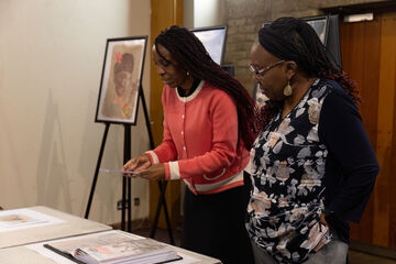two women look at a document on a table