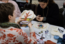 Photo of people participating in a stitching workshop