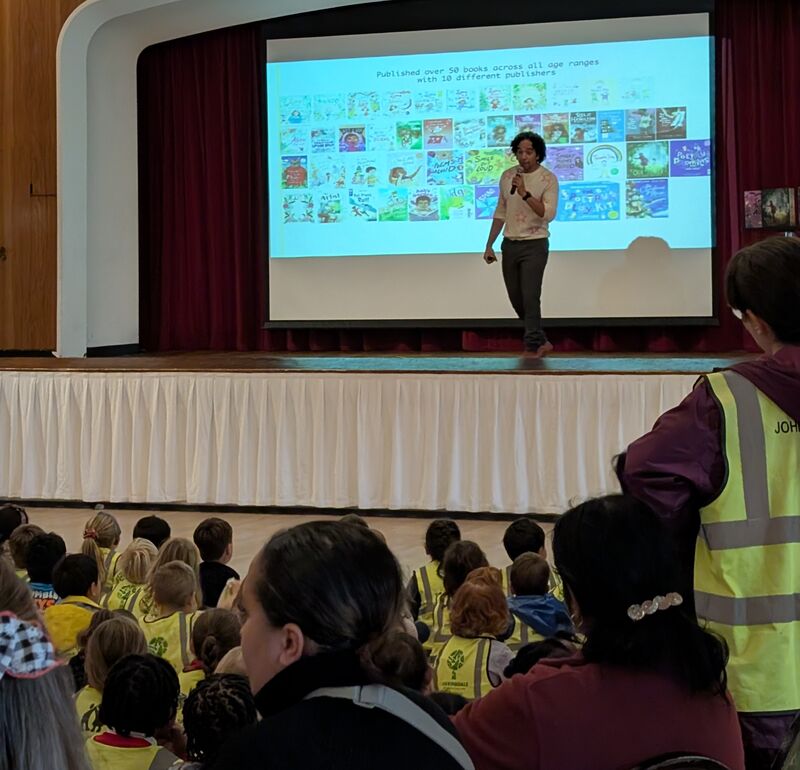 Joseph Coelho on stage in front of children