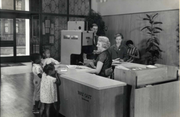 Alvering Library issue desk with young customers, 1961