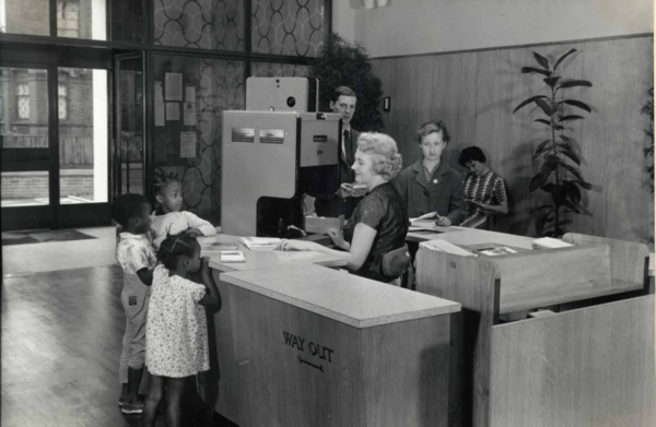 Alvering Library issue desk with young customers, 1961