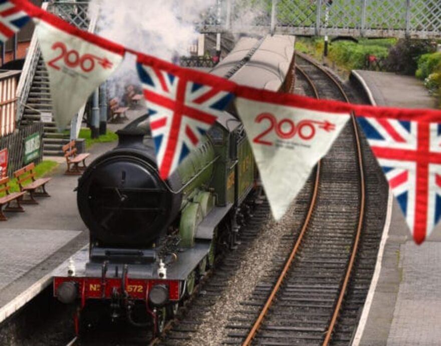 Steam train with banner celebrating 200 years