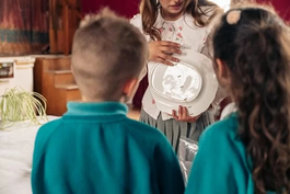 Children watching someone show something