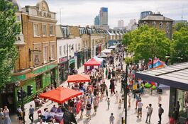 Busy and colourful stalls and gazebos on a car-free street