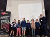 Chris Riddell and children in front of projector screen of drawings 