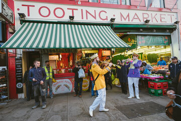 Colourful street band perm in front of Tooting Market
