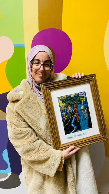 Tiah Algalarrondo holding textile artwork representing nativity in Islamic perspective for 9elms ministry “follow the star” exhibition in December 2023