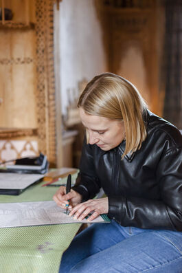 Chloe Campbell, Papercutting artist creating one of her designs at 575 Wandsworth Road