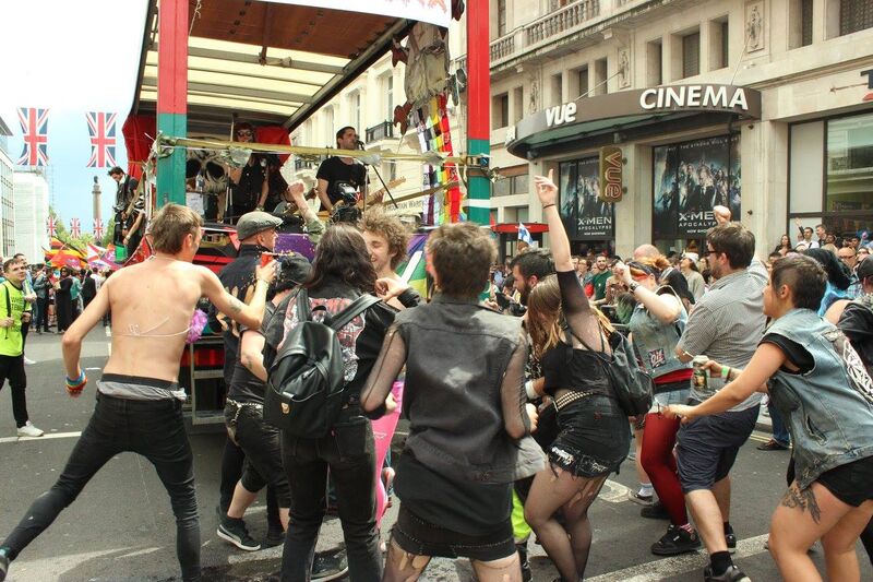 An Image Of Punks Dancing Behind A Parade Float