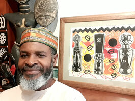 Photo of artist Ken McCalla with his artwork African dolls print