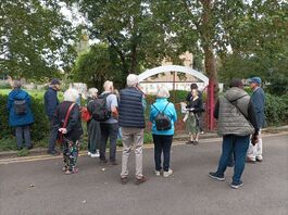 A group of people standing outside the entrance to Oasis Play Space