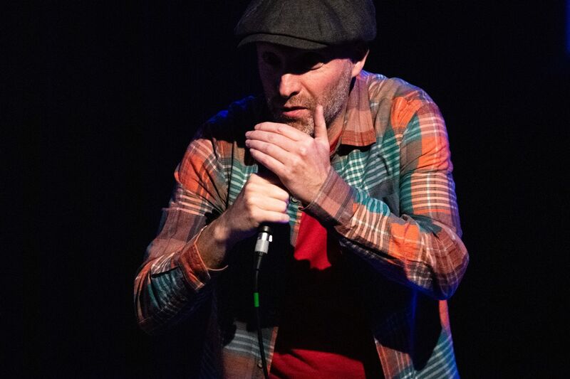 Storyteller at a stand up mic