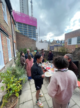 Photograph of a community meal outside WIP Space studios