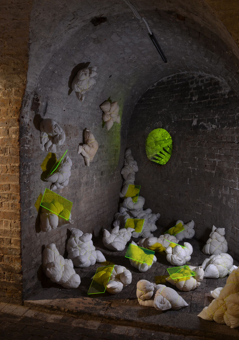 installation with tied pillows and yellow perspex in Crypt Gallery London