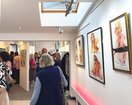 The Back Of A Womans Head Walking Through A Gallery