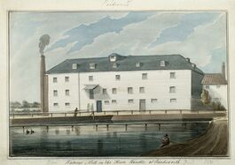 Watercolour painting showing Watney's Mill on the Wandle with boats in front of it and smoke coming out of the chimney.