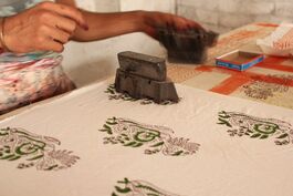 A photo of hands block printing