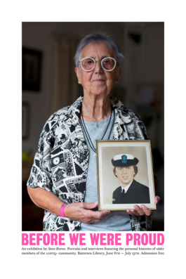 This photograph shows a woman (Vito) holding a portrait of herself as a young woman and a naval wren. She is around 70 and is wearing round white spectacles and a patterned black and white cardigan.