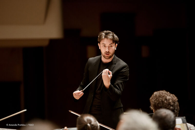 Conductor Oliver cope in action conducting an orchestra