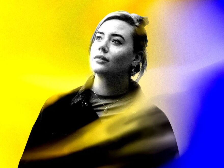 A black and white photograph of mezzo-soprano Bette Lotts-Dean on a purple and yellow background.