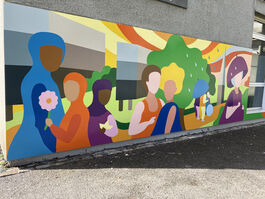 A section of a colourful mural showing a variety of stylised people with grass and trees in the background.