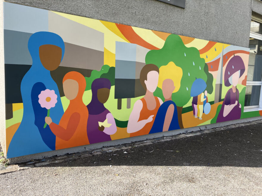 A section of a colourful mural showing a variety of stylised people with grass and trees in the background.