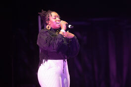 Teenage girl singing in a microphone
